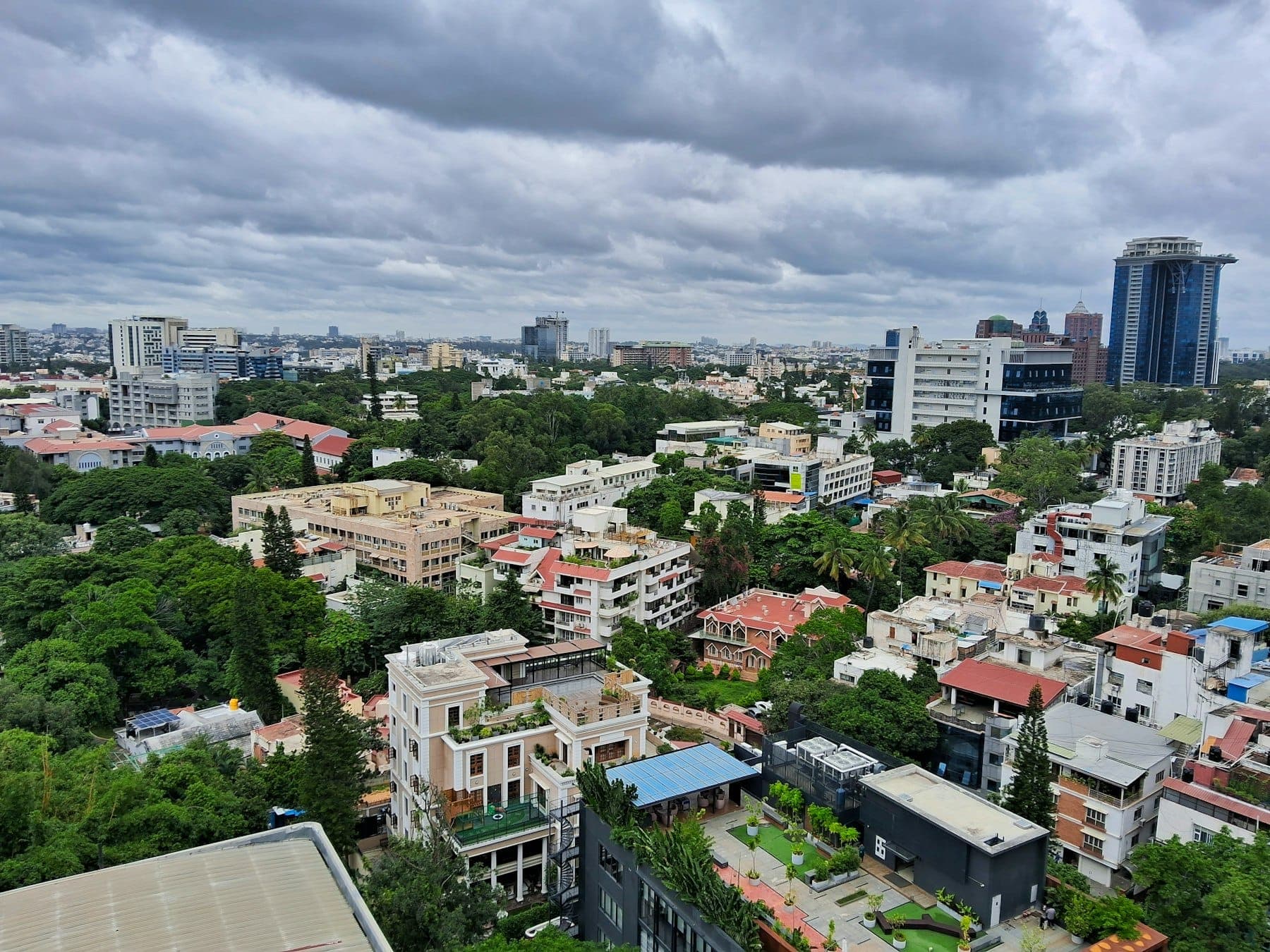 Aerial view of dense Bengaluru neighborhoods, tree cover, and city blocks that reflect the scale of India's largest technology ecosystem.
