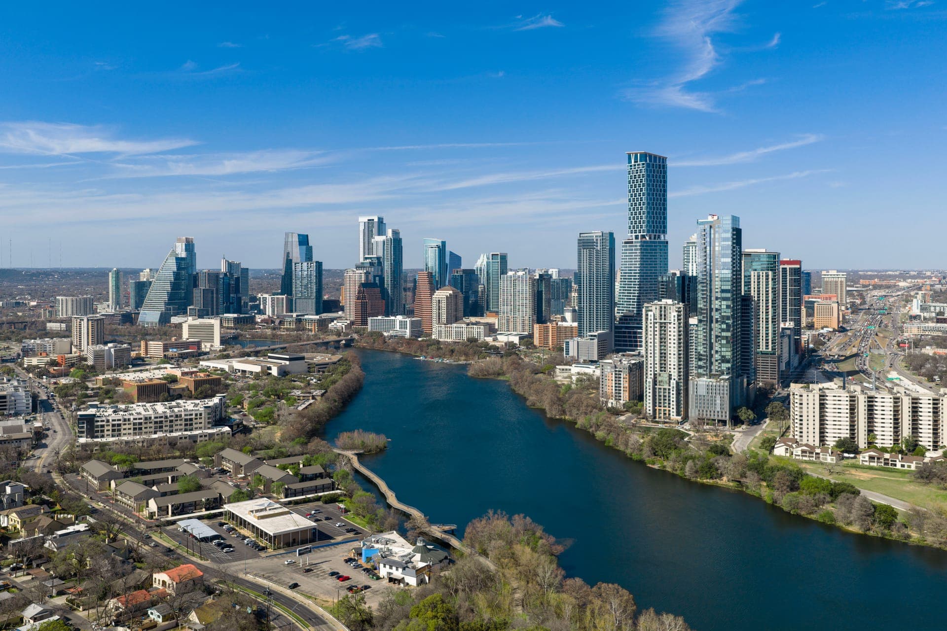Austin, Texas skyline viewed from above, showing downtown towers and the surrounding city grid.