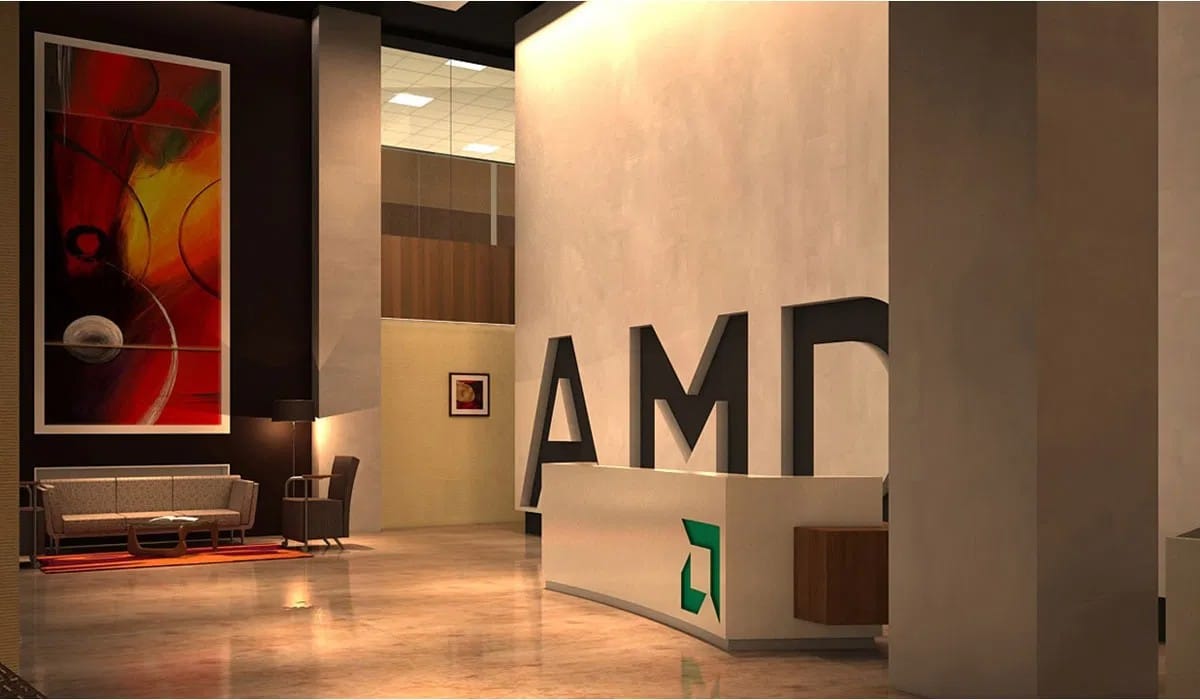 Office reception with large AMD lettering, a branded reception desk, lounge seating, and warm lighting.