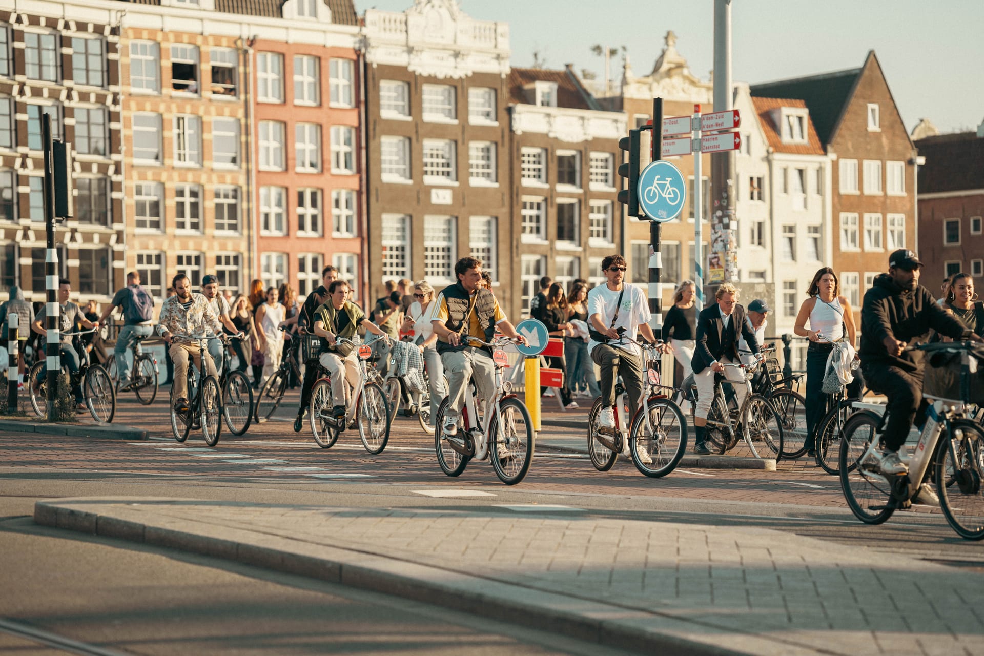 Cyclists commuting through central Amsterdam, showing the bike-first transport culture many Amsterdam tech workers rely on.