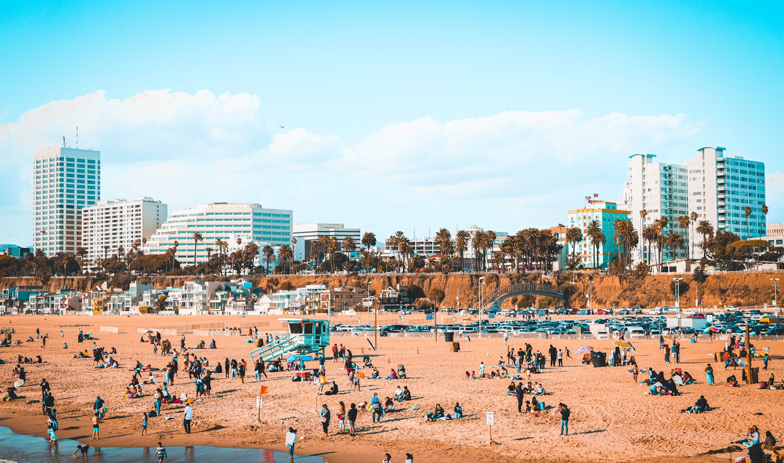 People spending the day on Santa Monica Beach with the coastal skyline behind them