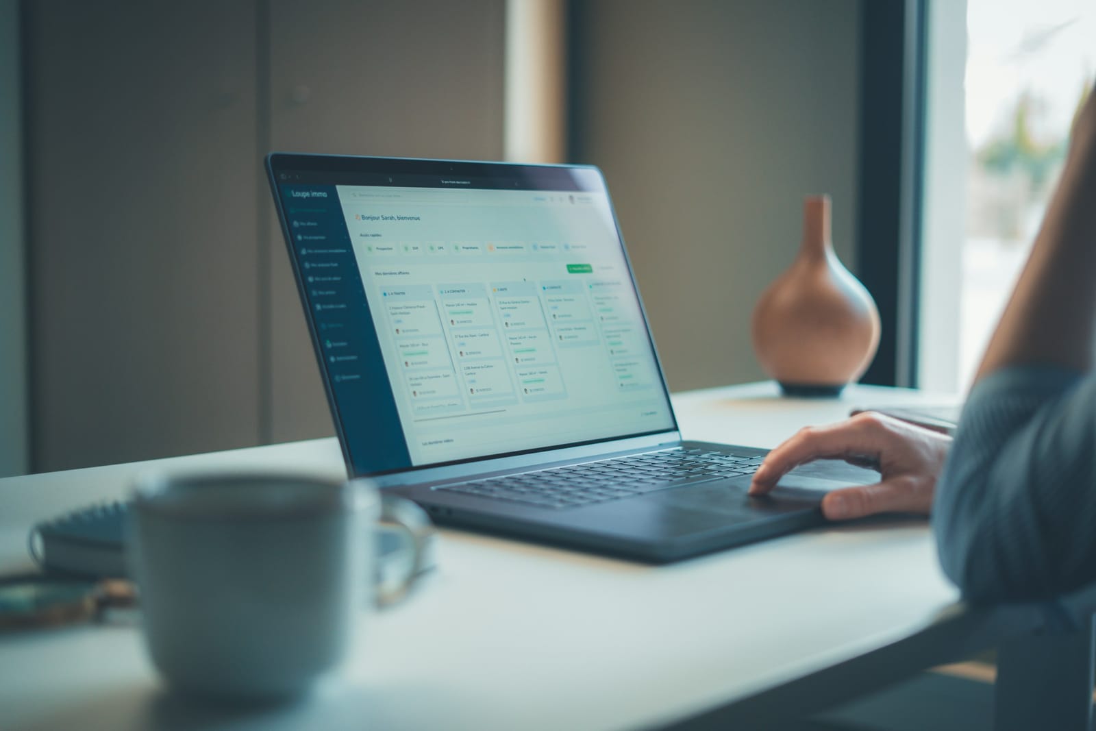 A person reviewing an online dashboard on a laptop at a desk.