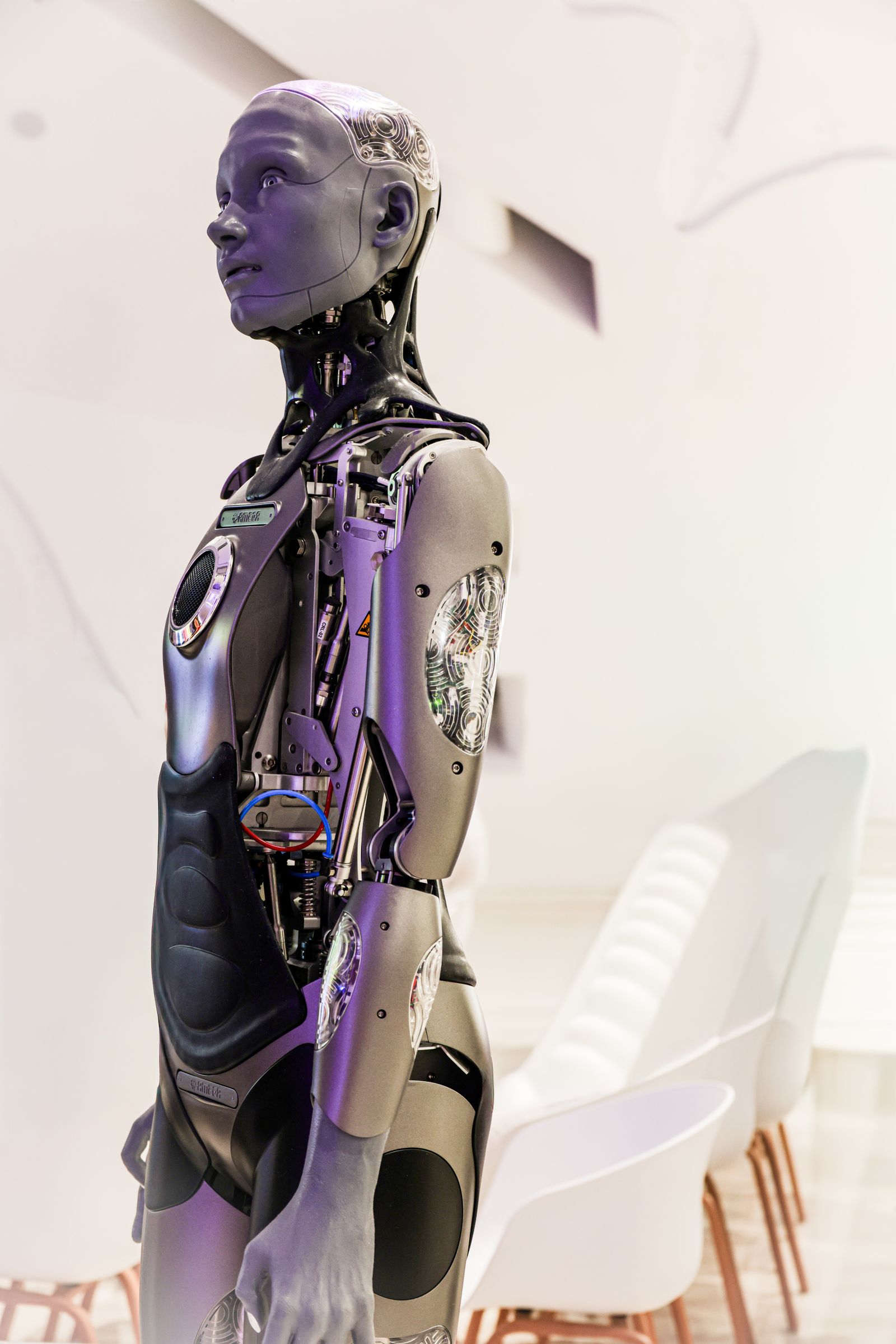 A futuristic robot in a modern conference room, representing the difference between AI assistance and replacing candidate judgment in the job search.