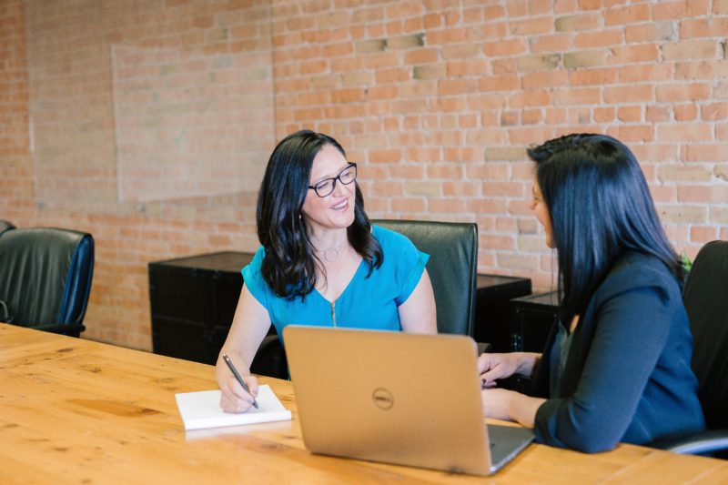 A professional career planning workspace with a laptop and notebook, representing structured goals and coaching preparation.
