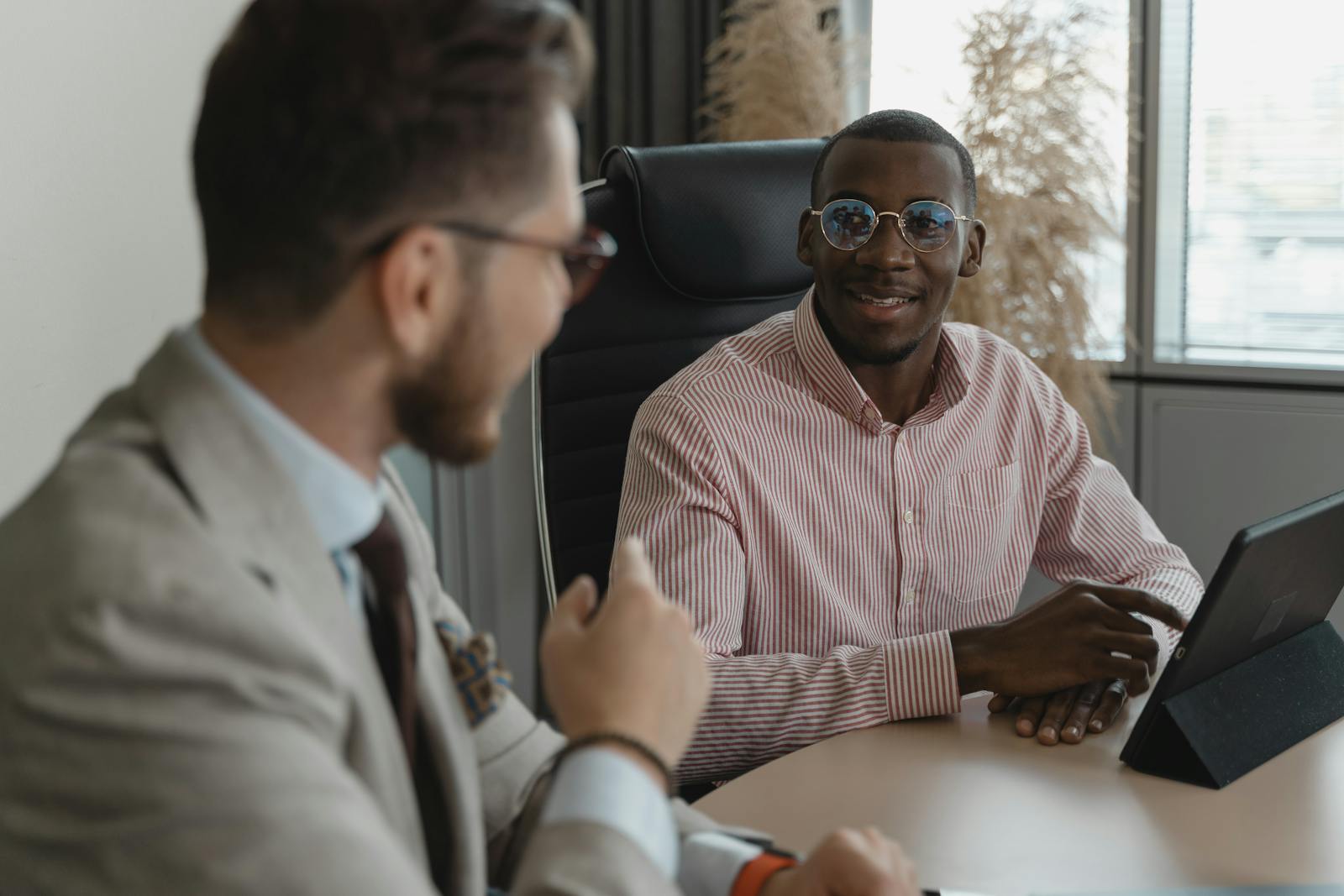 A candidate in a professional interview conversation, representing the 60 to 90 second professional introduction that opens most job interviews.