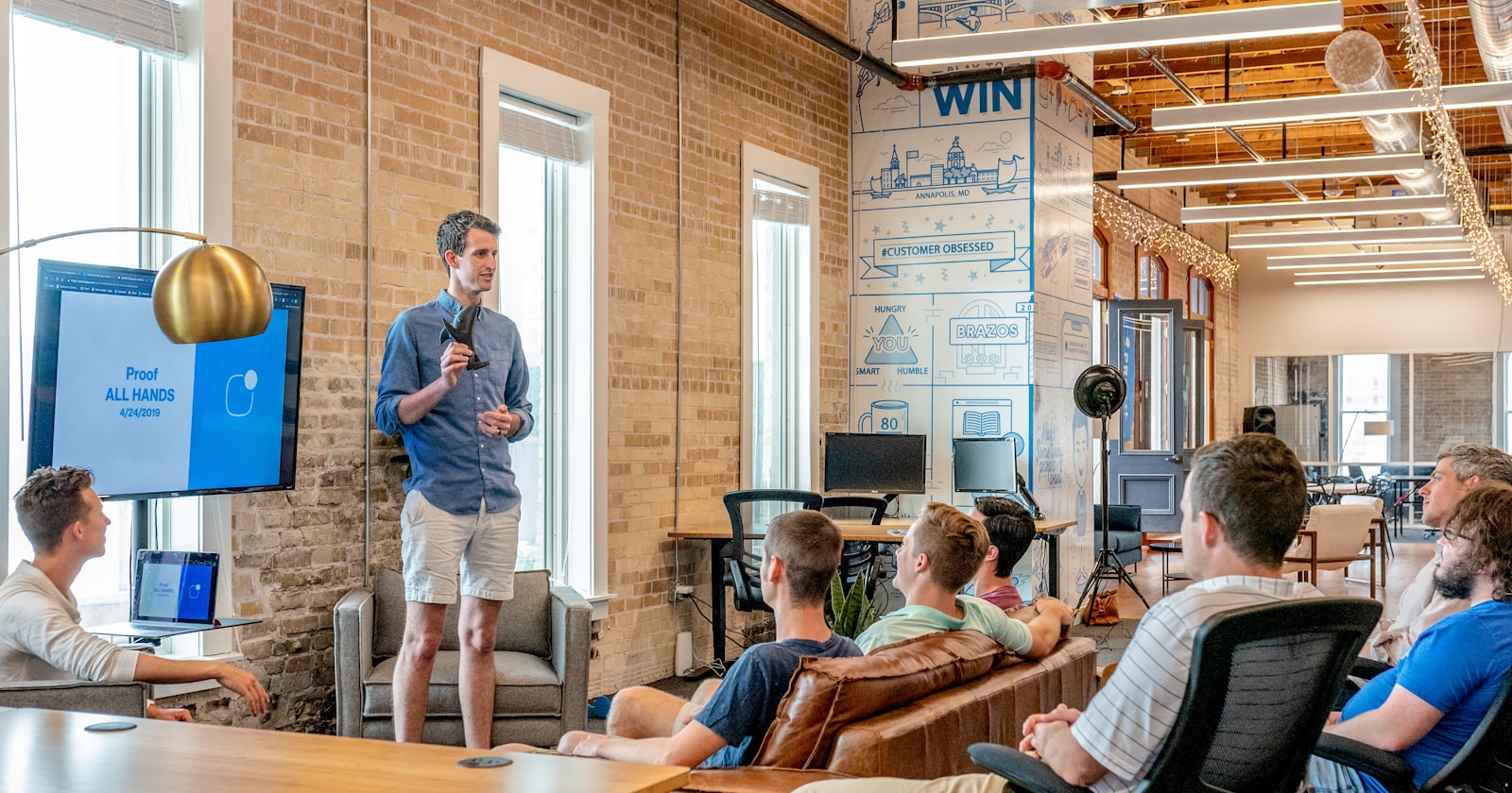 A small team in a candid workplace discussion, representing the team culture and dynamics candidates should assess during interviews